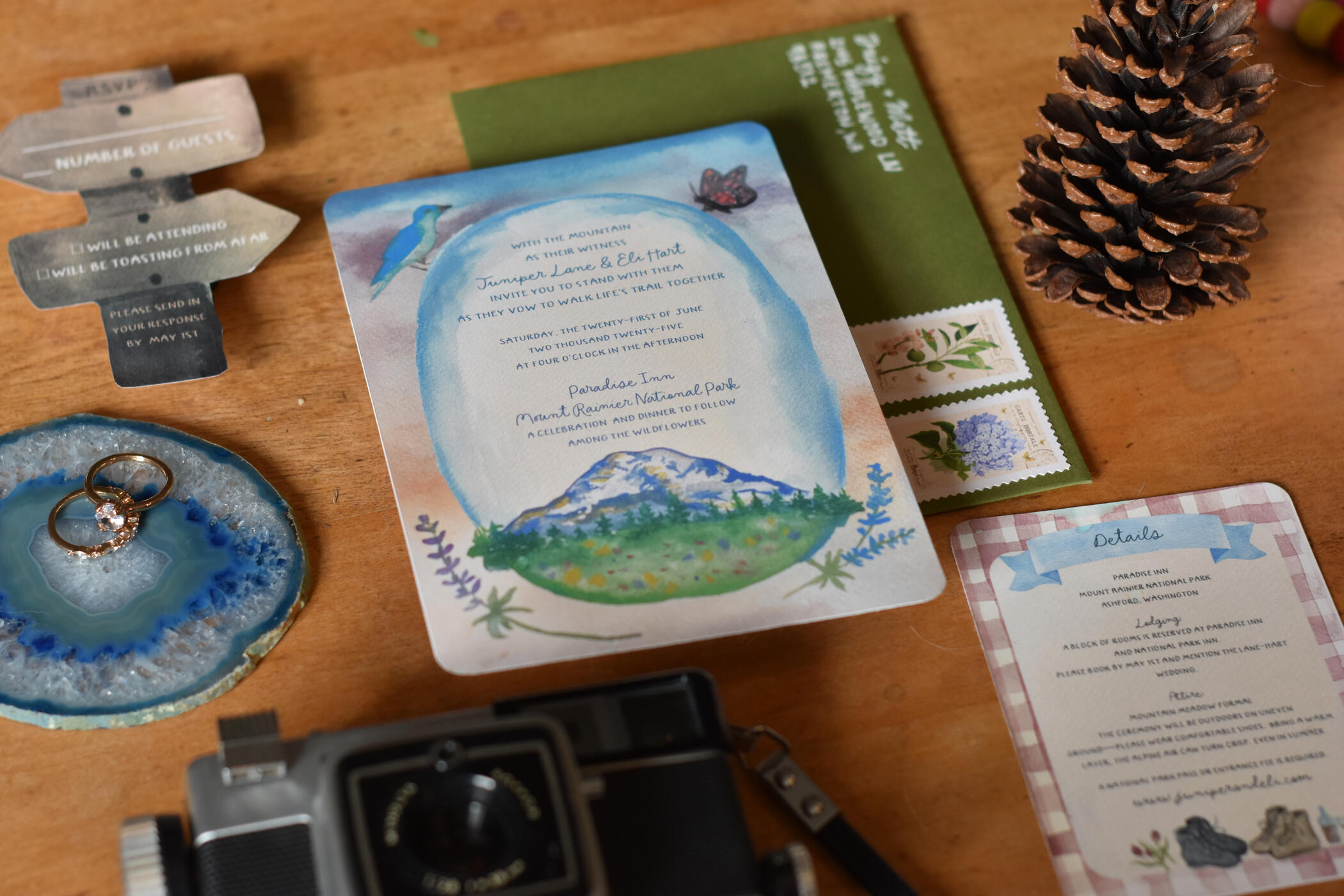 Mount Rainier Suite Watercolor wedding invitation featuring Mount Rainier with a bird, butterfly, and fern detail.